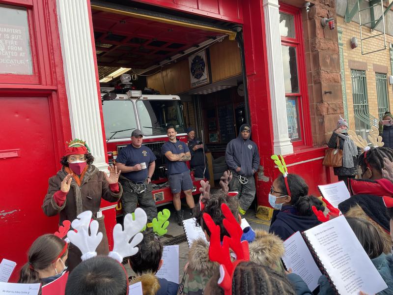 Panther Holiday Carolers sing to firefighters