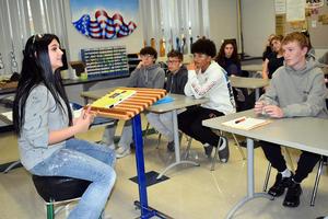 A teacher talks with students