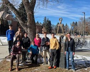 Students standing for a group picture outside