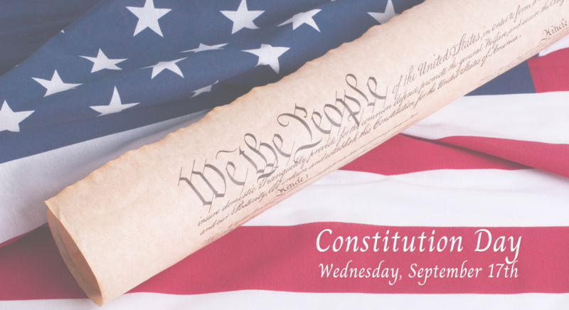 Rolled US Constitution on a background of the American flag. Text about Constitution Day
