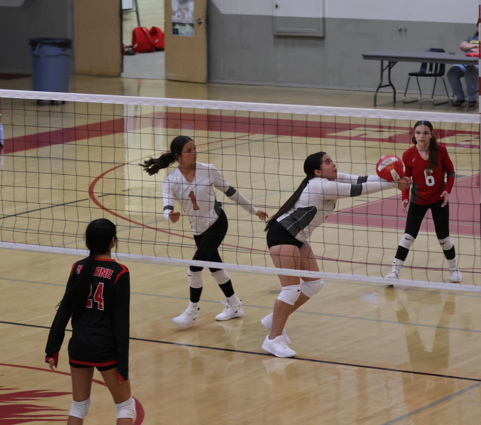 junior varsity girls playing volleyball 123