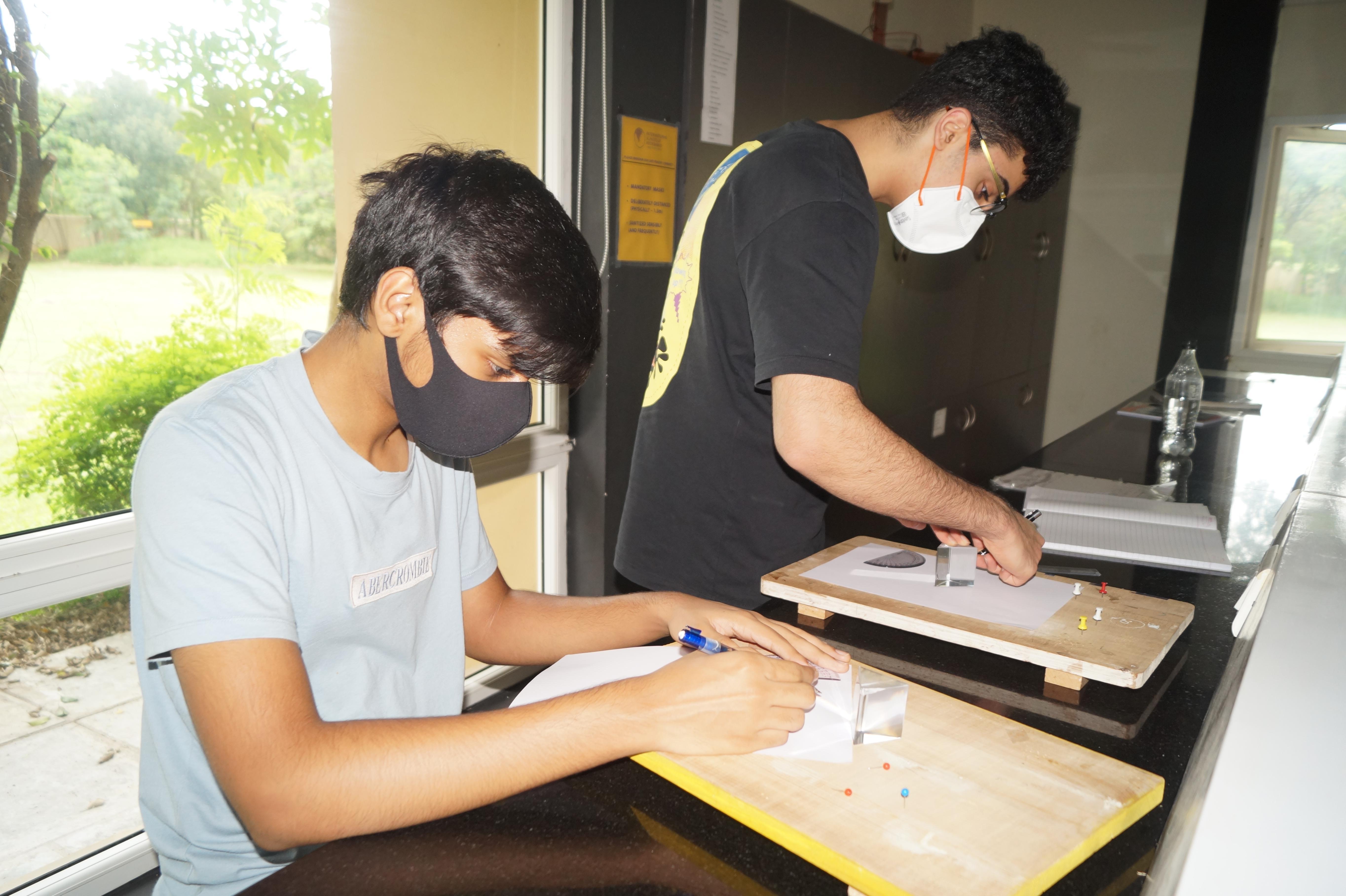 Two students doing geometry