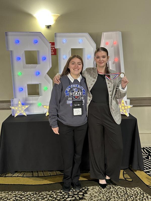 Two MHS BPA students posing with their state medals