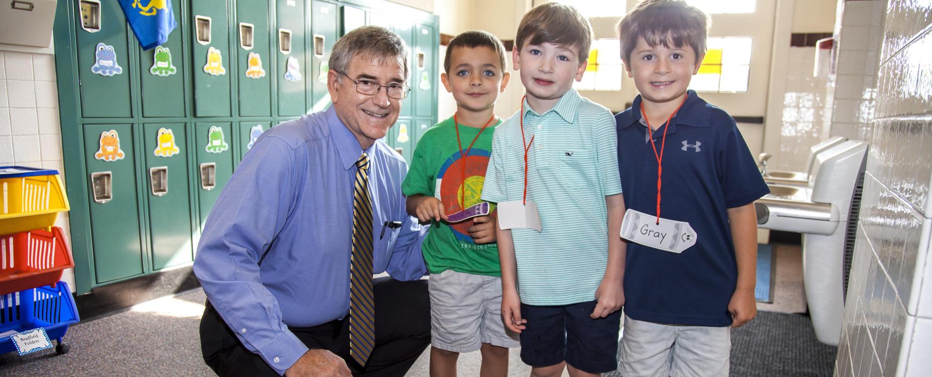 Dr. Trigg with students in hallway.