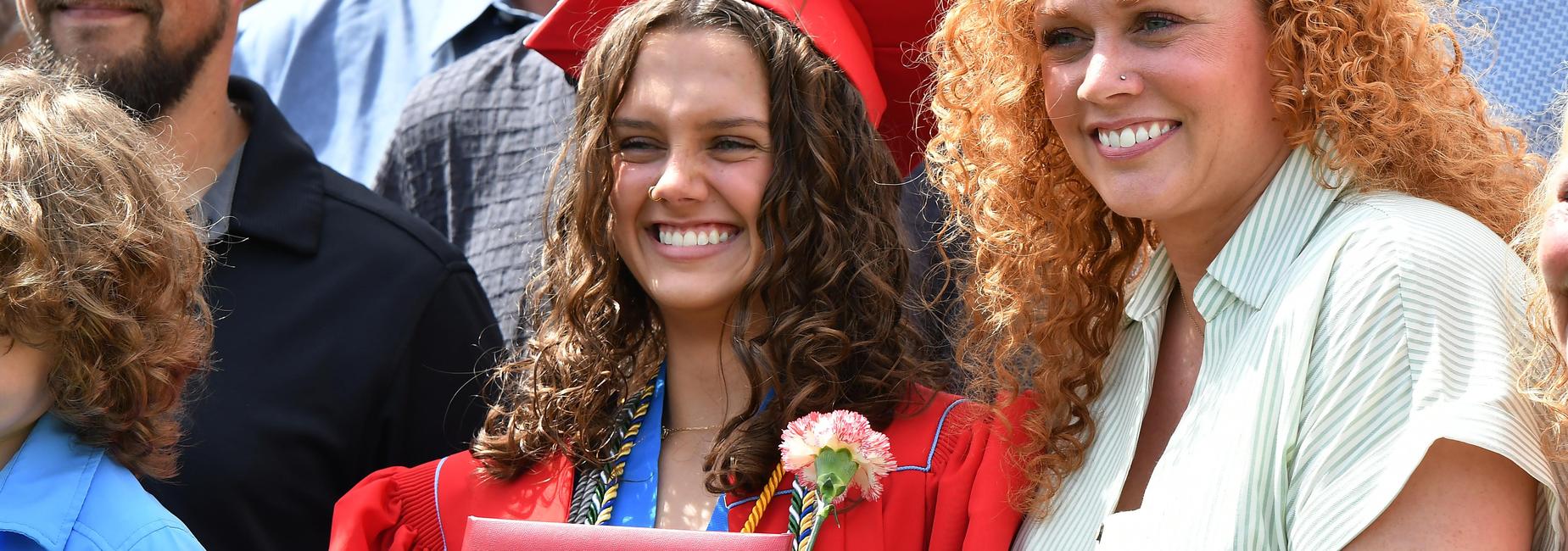 Graduate holding diploma.