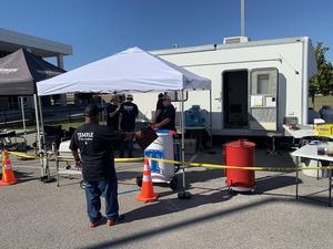 Head coach Joe Medrano talks to Temple Pitmasters team members during Saturday's cookoff