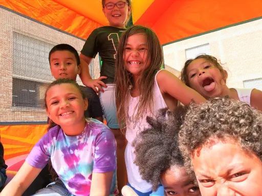 kids smiling in an orange tent laughing and having fun