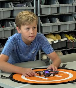 Students working with drones in a STEAM classroom.