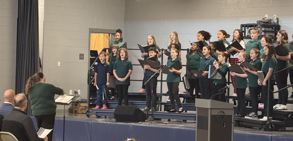 Student choir singing on stage