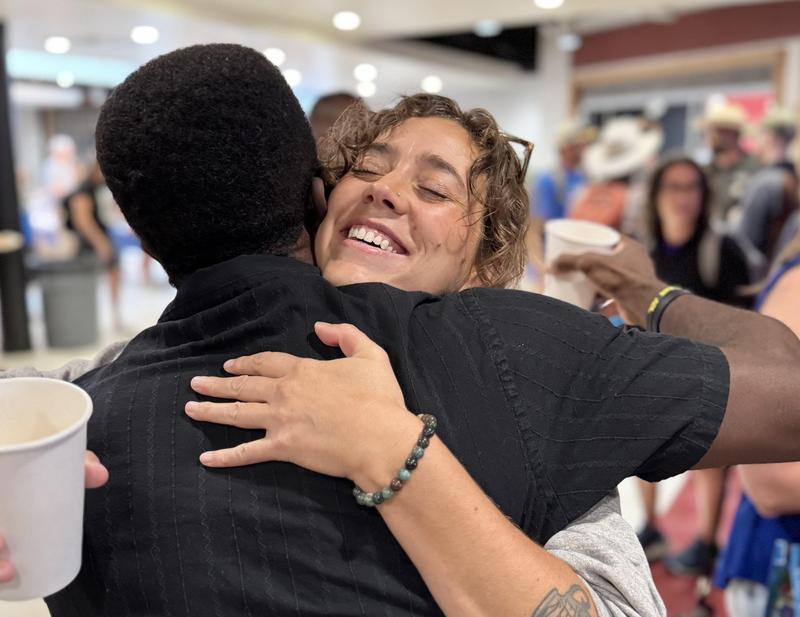 Man hugs woman