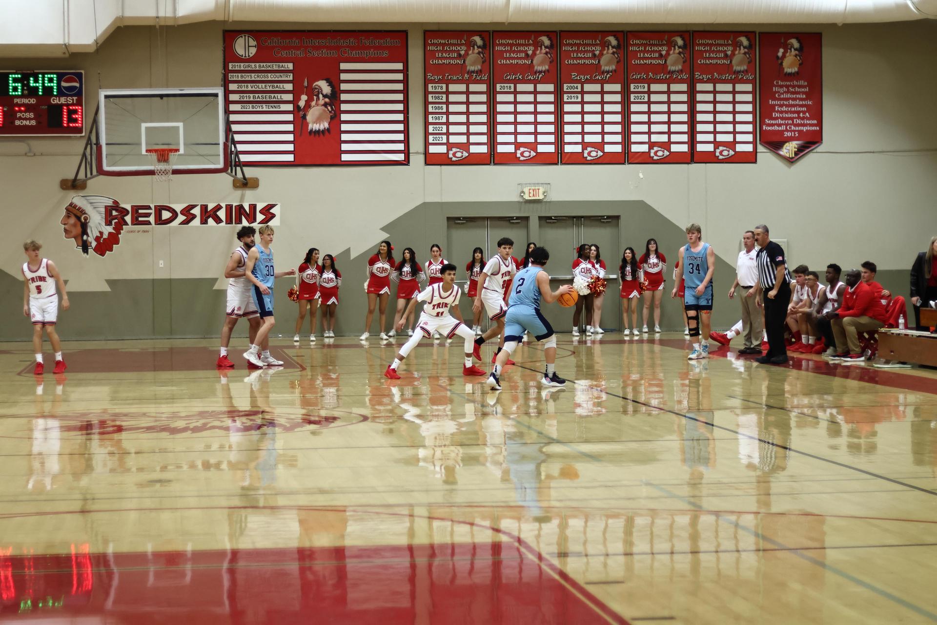 Varsity boys playing basketball against yosemite