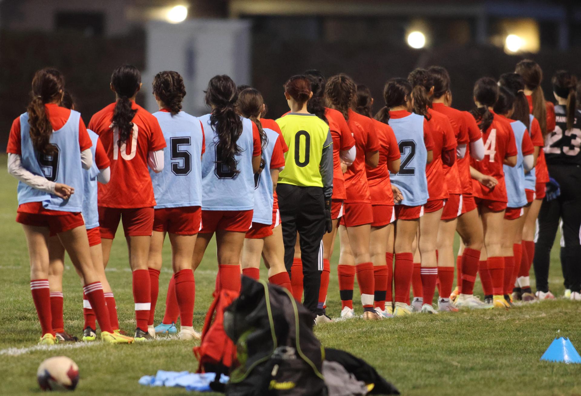 Varsity girls playing soccer against sunnyside