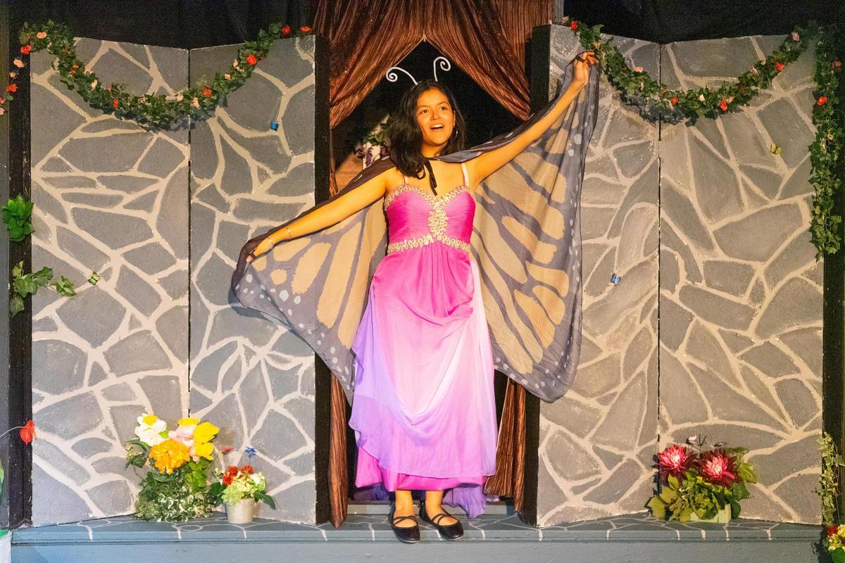 Student performing in theatre as a butterfly