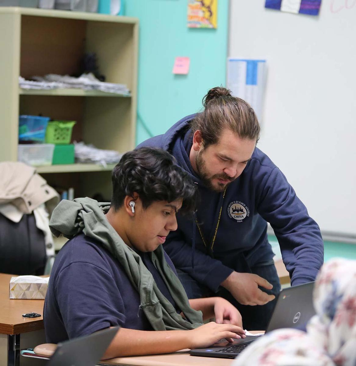 Student and teacher collaborating in a classroom.
