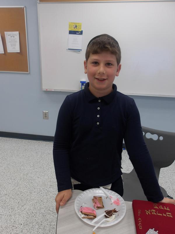 A fourth grade student showing his finished shofar sandwich