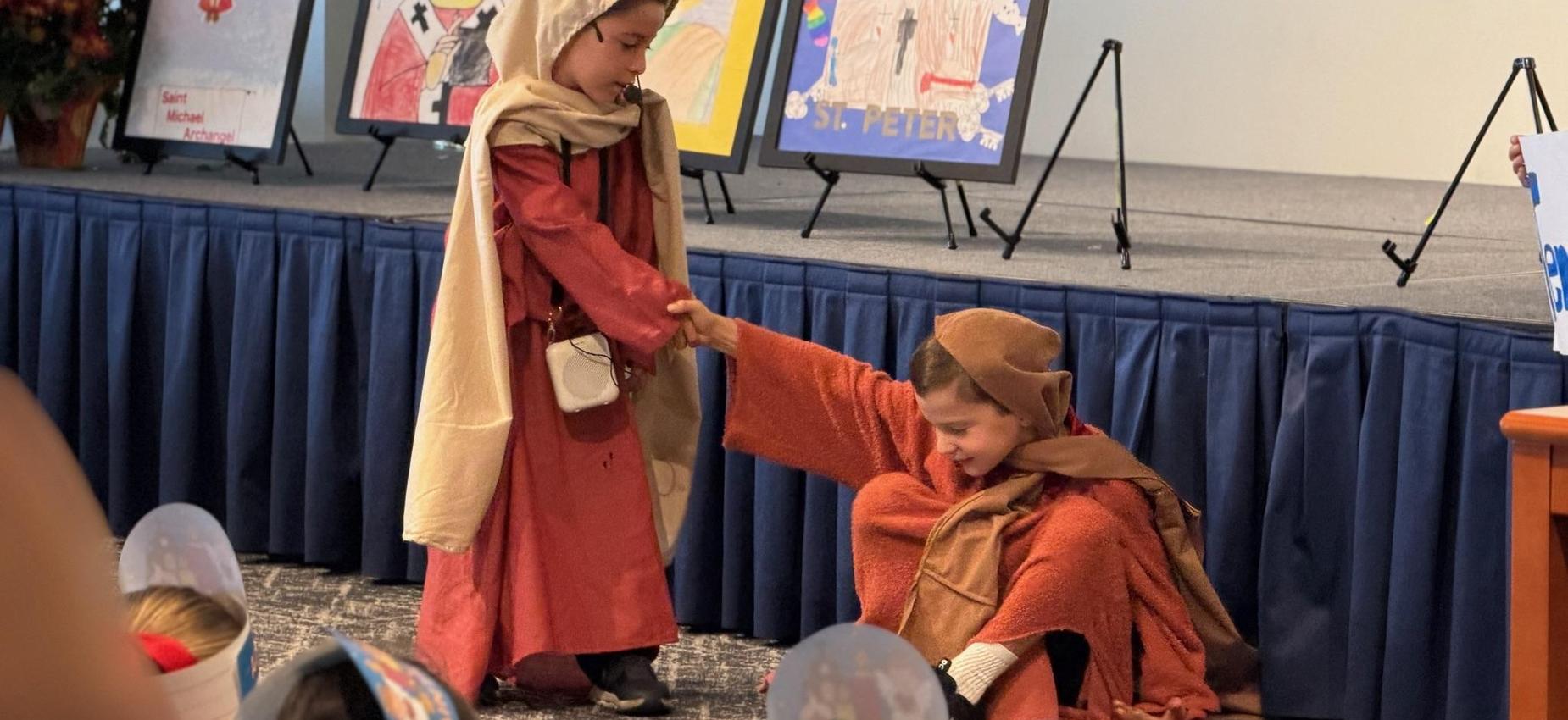 2nd grade students act out a scene from St. Peter's life