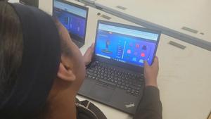Student coding online and playing a game