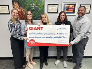 Image of 5 people holding a check from GIANT in the amount of $7583.50