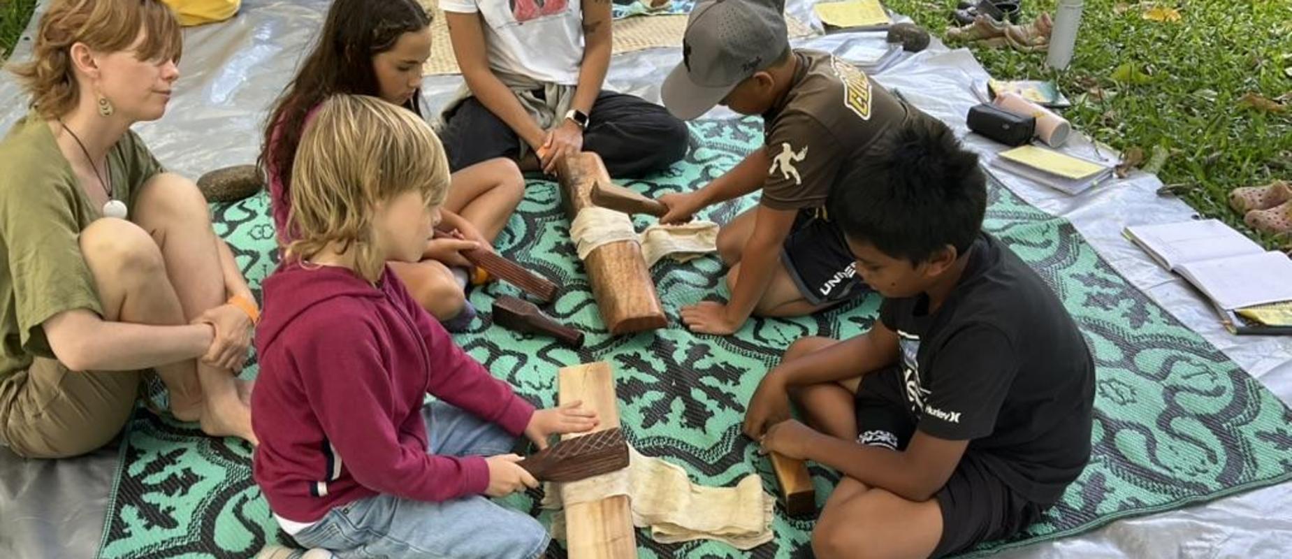 Fourth graders making kapa