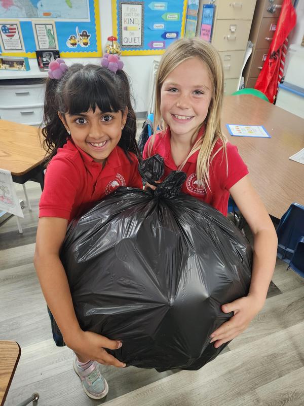 Arya and Jett recyling water bottles