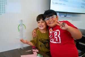 Two students posing with their STEM lab project.