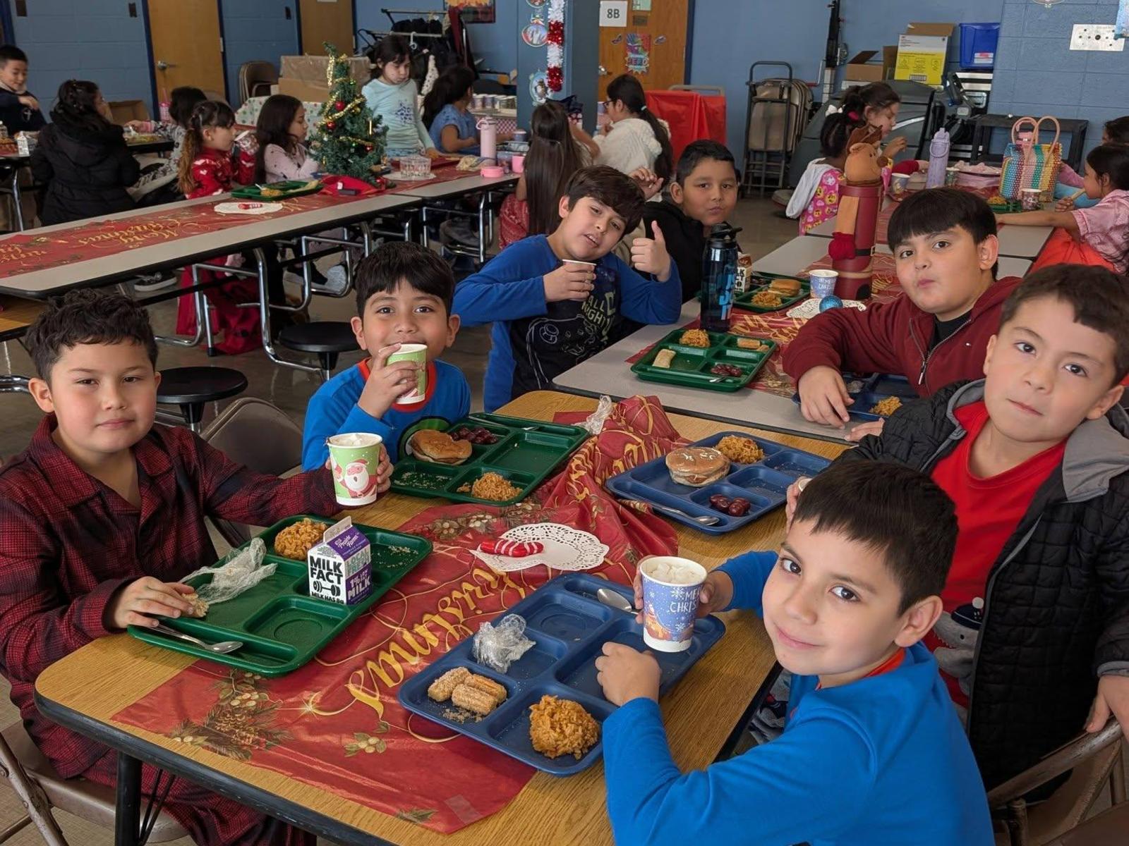 Boys having hot cocoa before Christmas