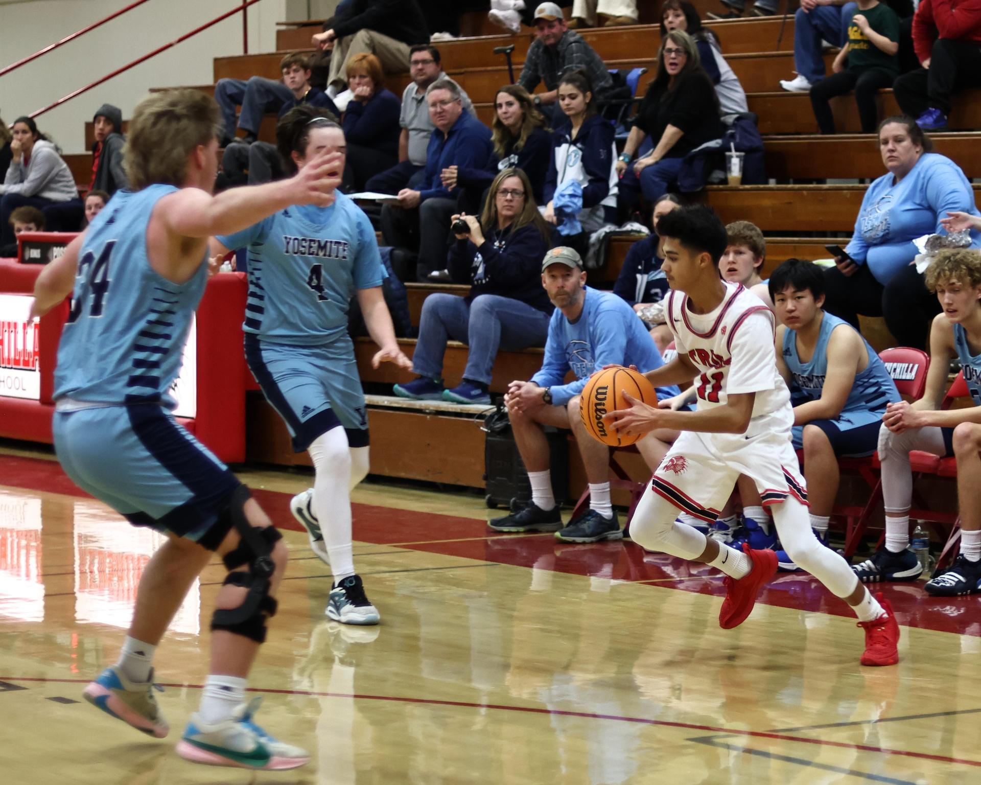 Varsity boys playing basketball against yosemite