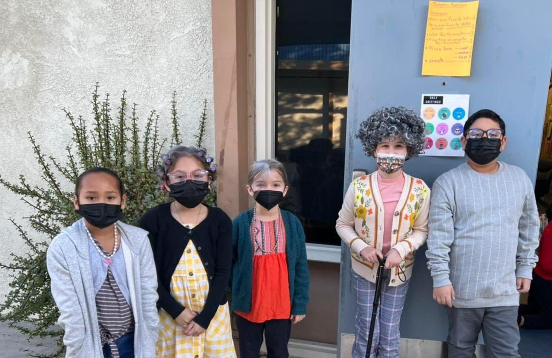 Decker Scholars are posing in front of school
