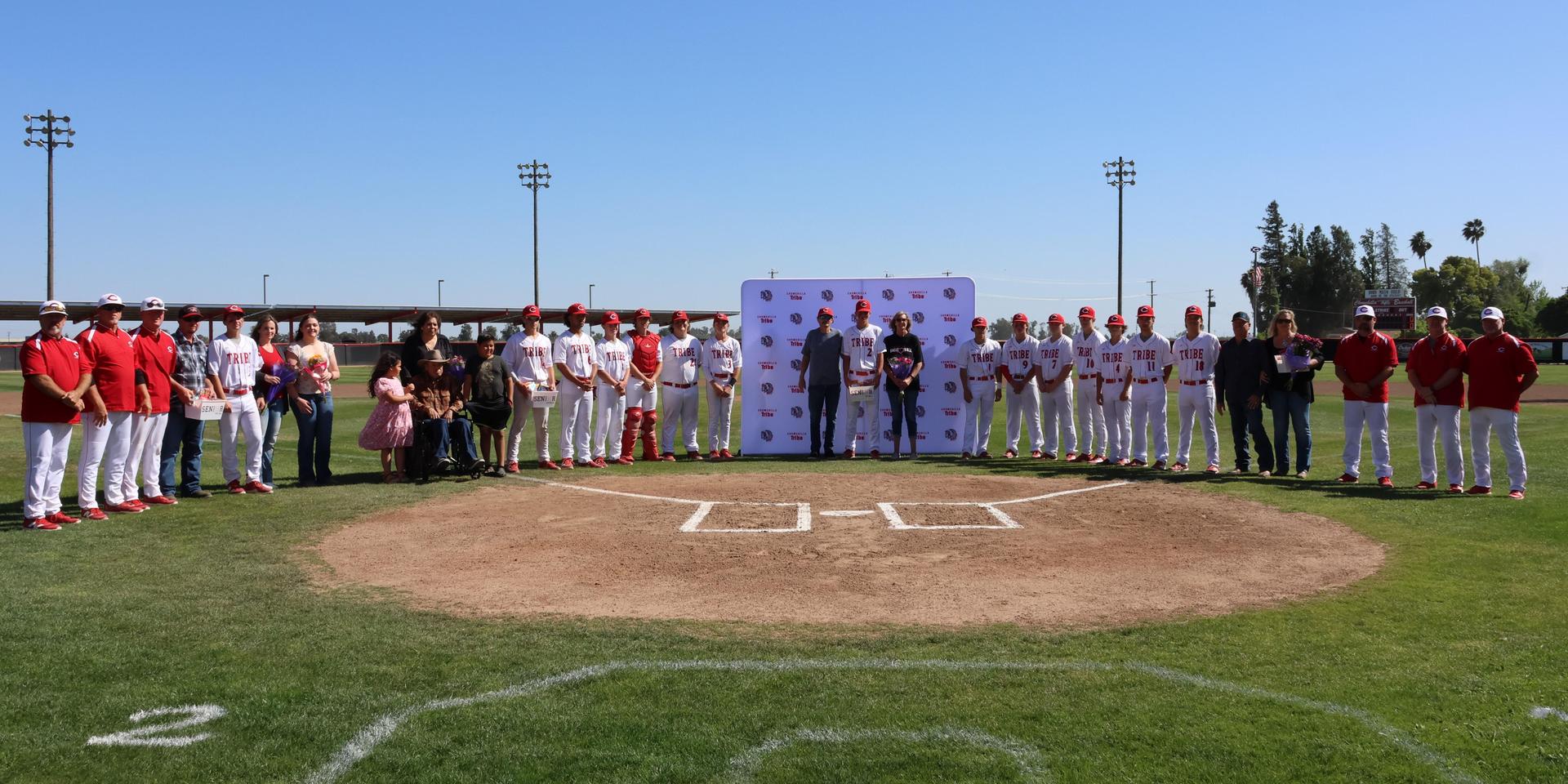 Seniors Posing With Teammates, Coaches, And Family