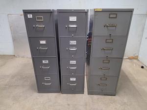 Three gray file cabinets arranged side by side