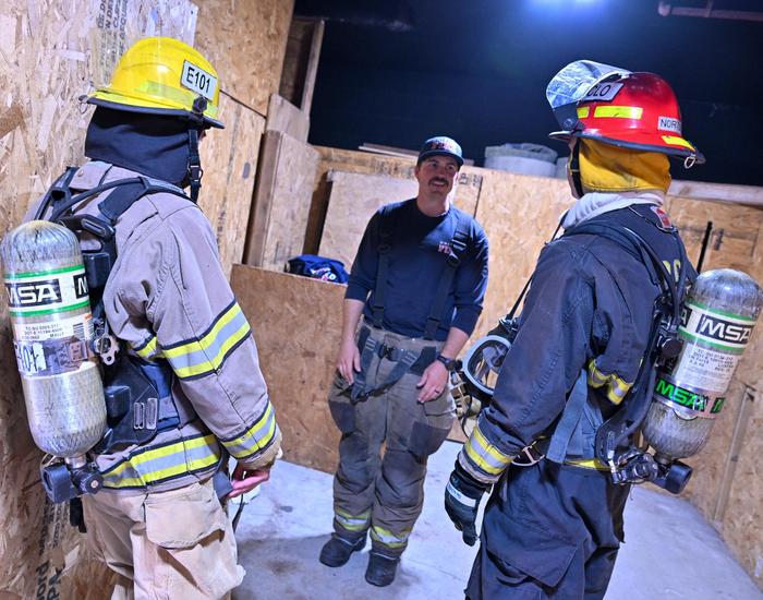 Fire fighter teacher talking to students