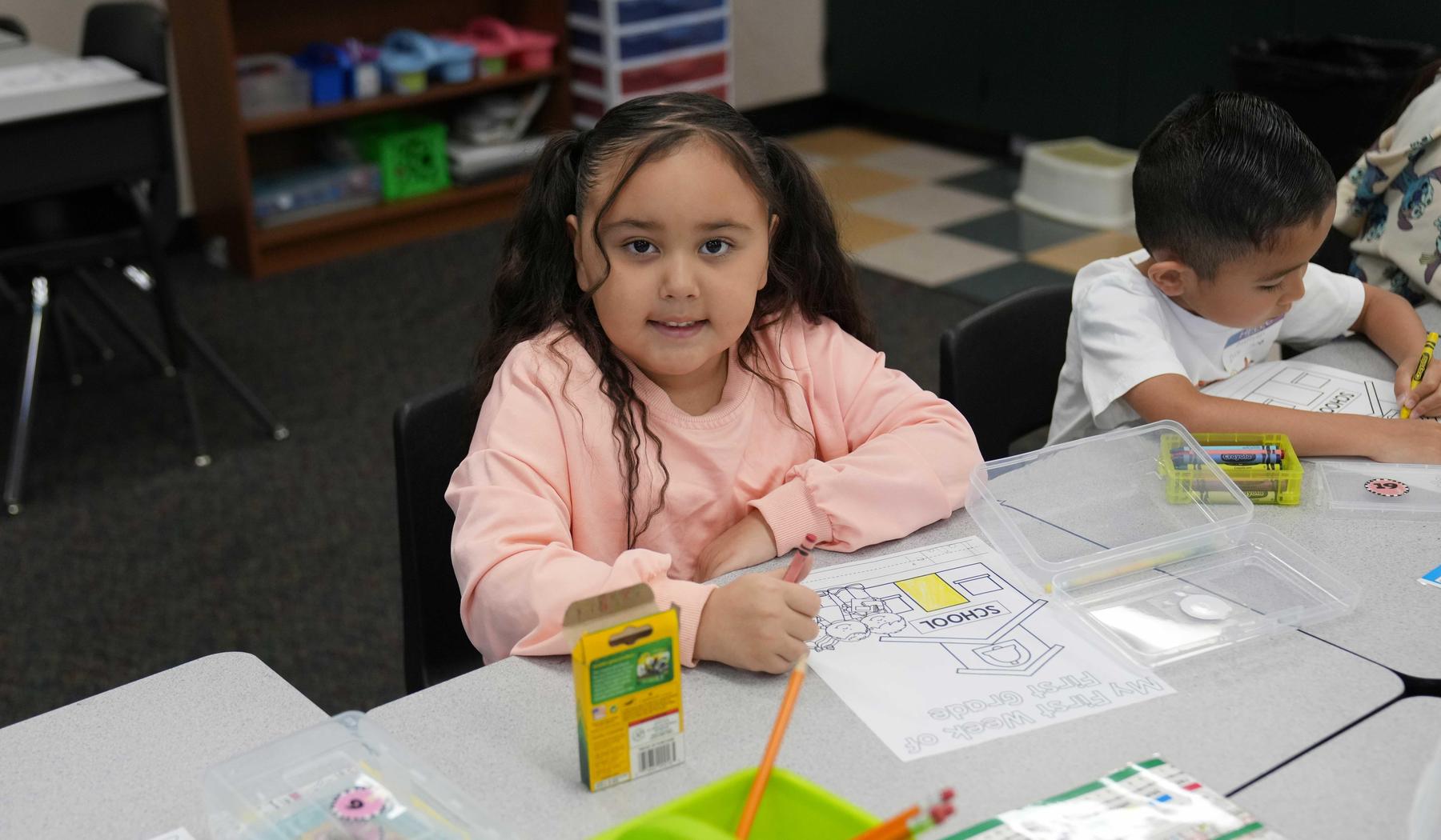 elementary girl coloring a picture