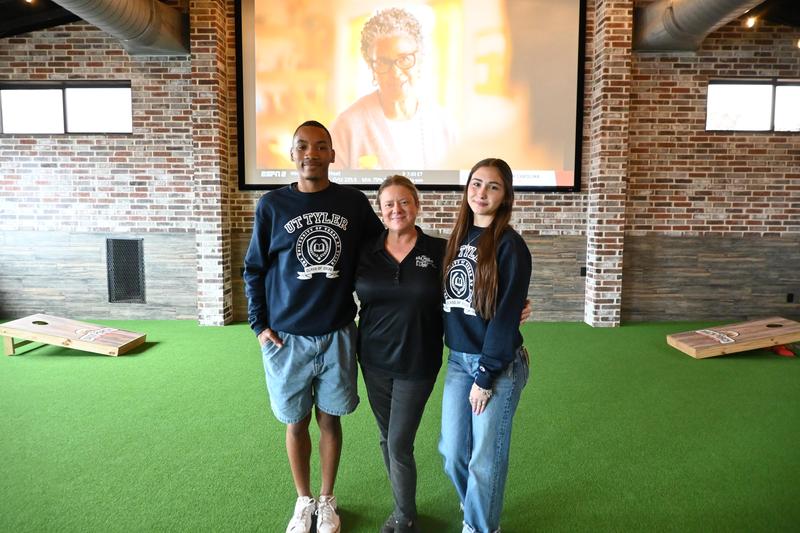 Two seniors posing with the manager at The Back Porch.