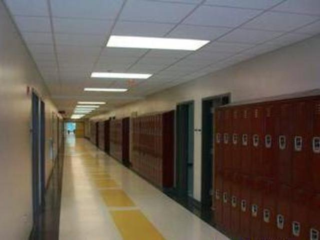 School hallway lined with lockers and lights.