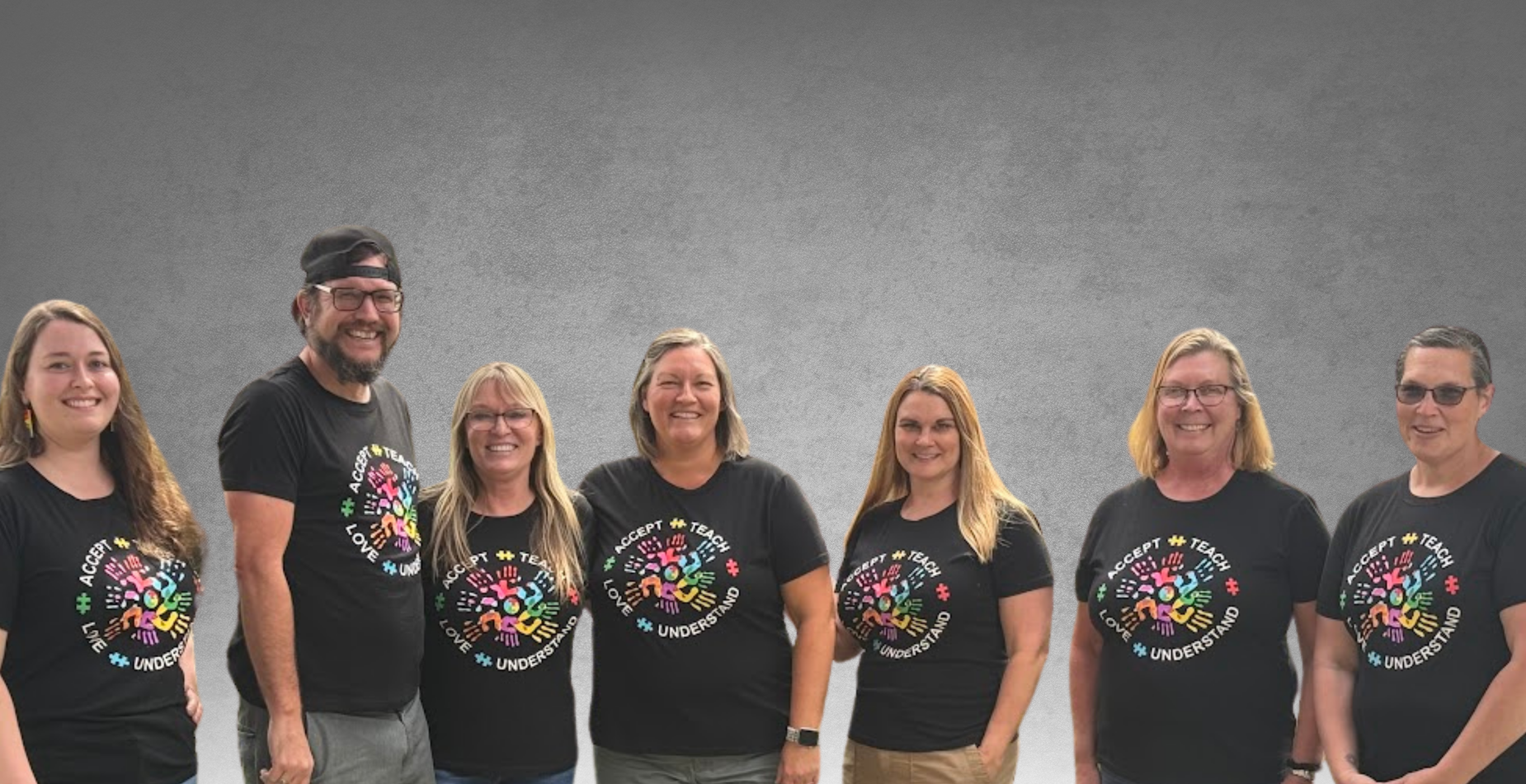 Staff Members wearing rainbow handprint shirts