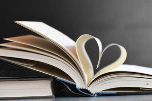 a book with pages folded into a heart symbol