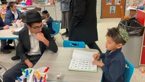 A boy learning with a kindergarten student.