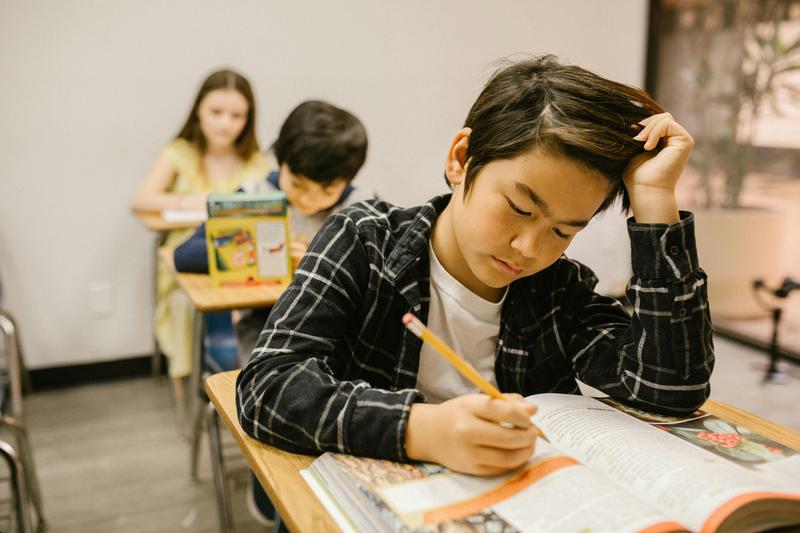 student sitting at desk doing school work