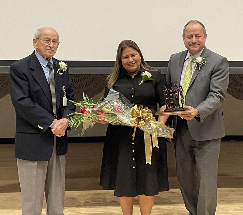 Maria with region officials and award