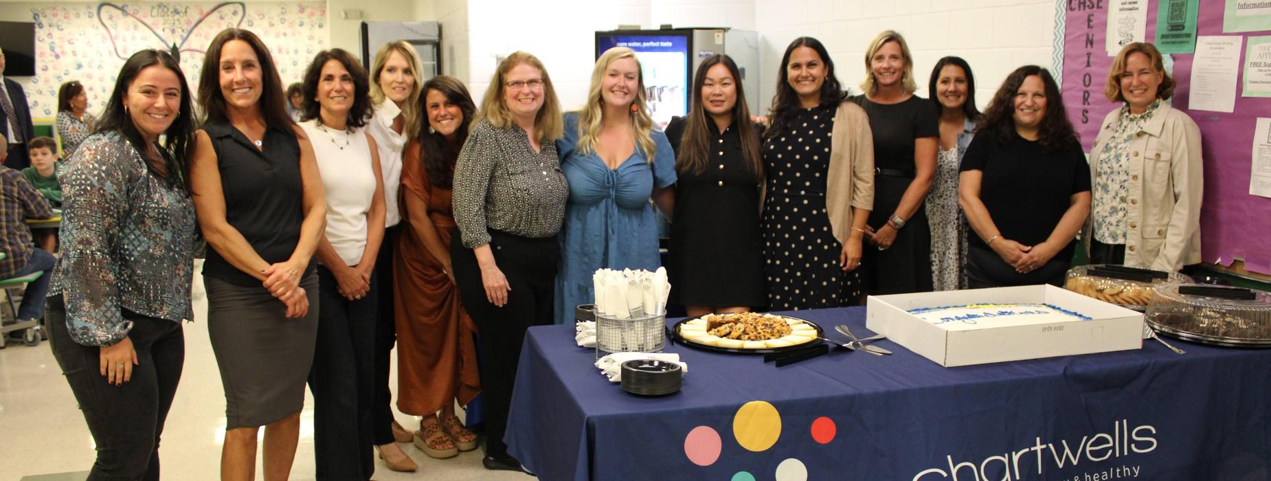 Teachers of the Year pose in front of their Congratulations cake at the reception after the school committee meeting.