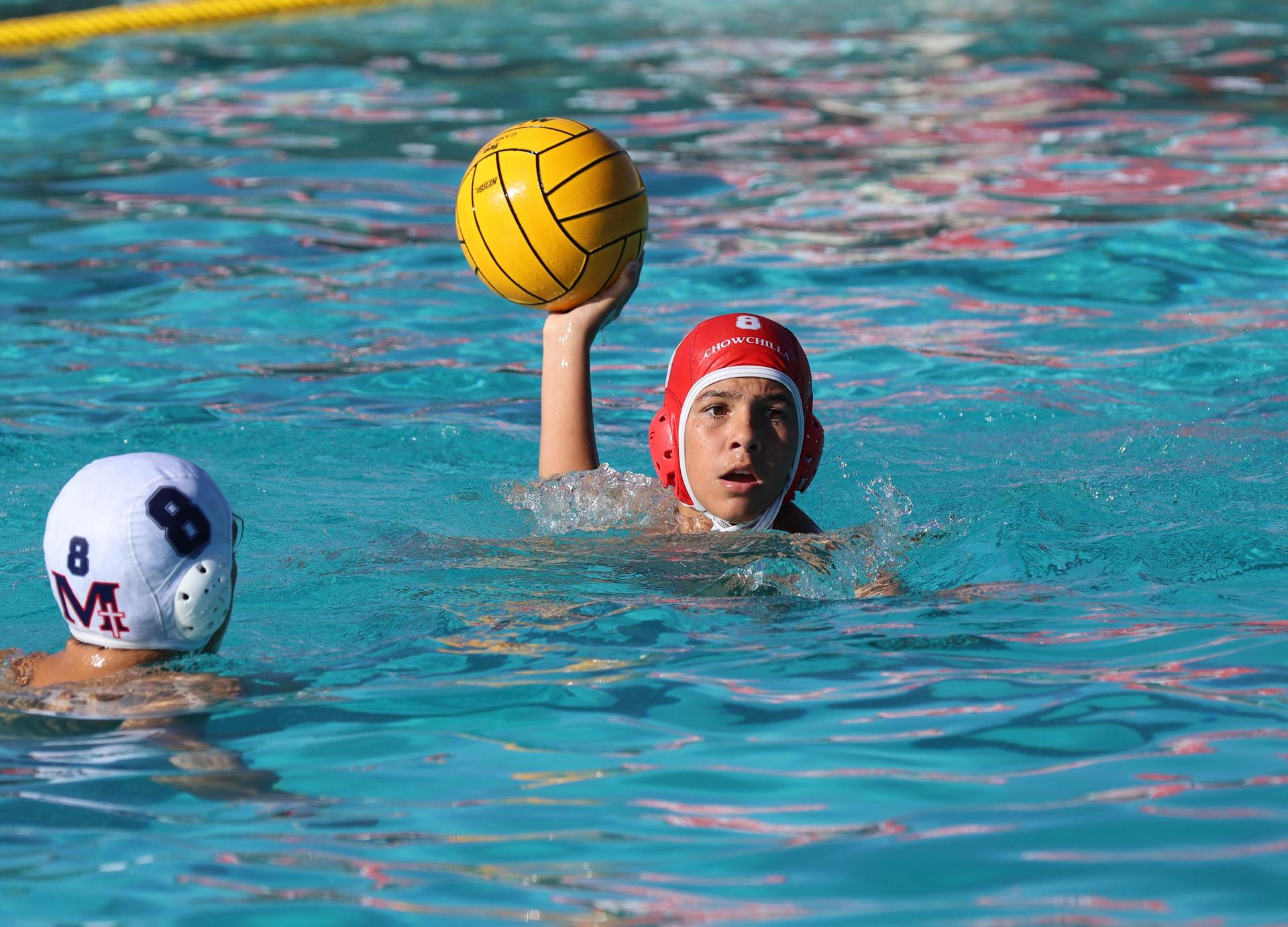 boys water polo players in action against san joaquin memorial