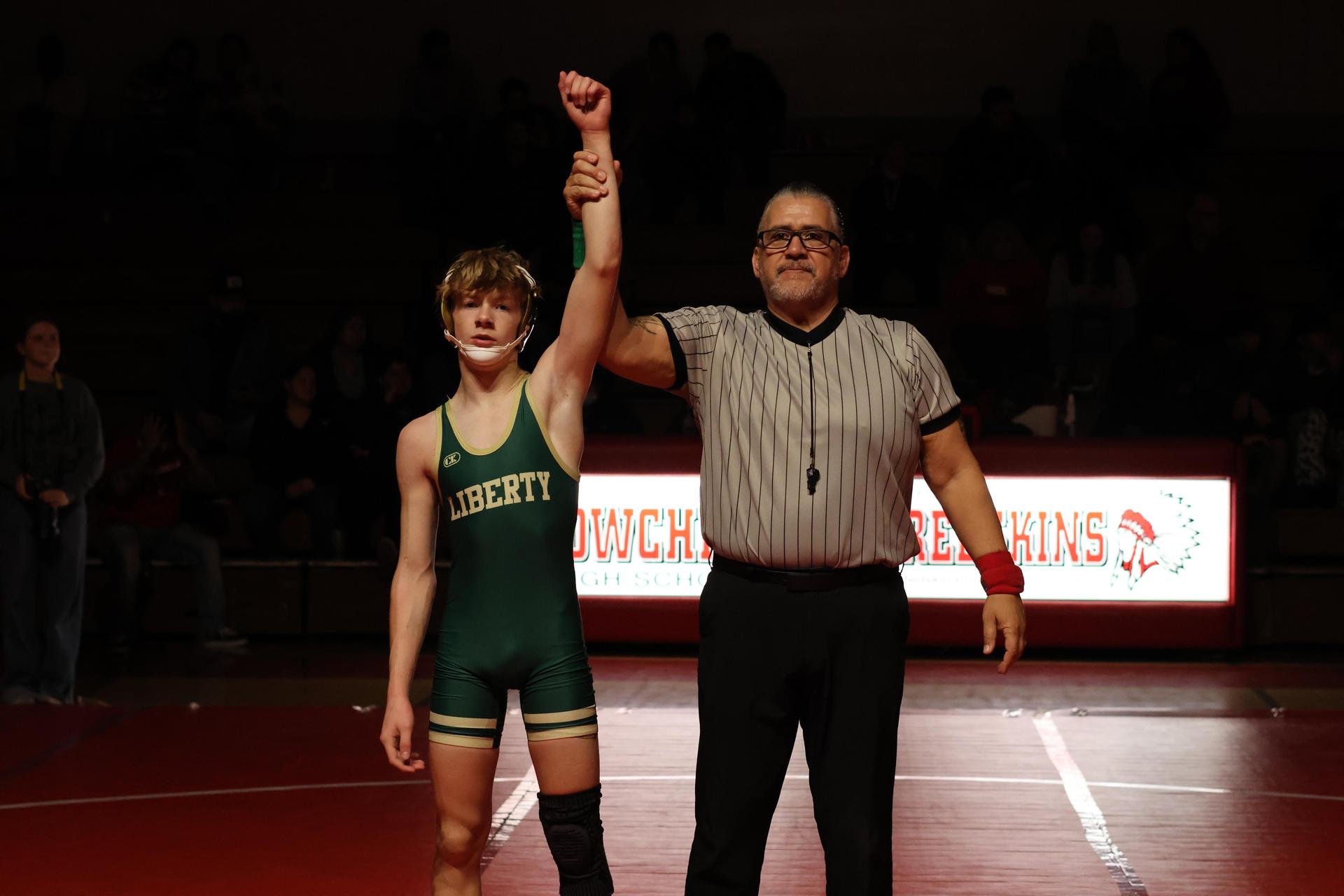Wrestling winners with hands up 112