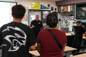 Teacher talking in classroom during back to school event