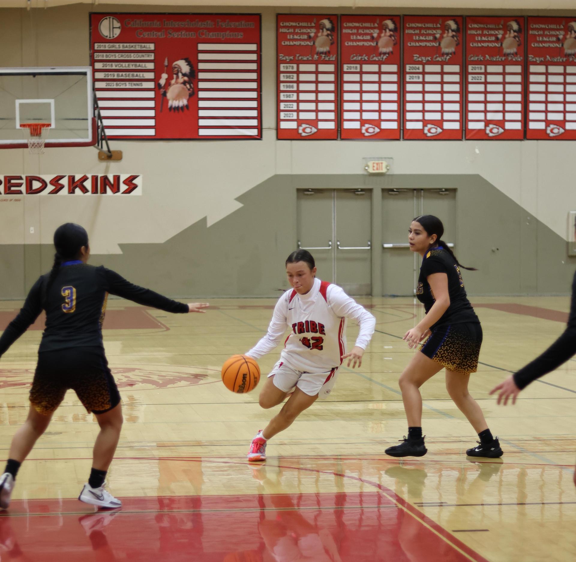 junior varsity girls playing basketball against parlier