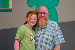 Family posing at smiling together at Legacy Family Steam Night