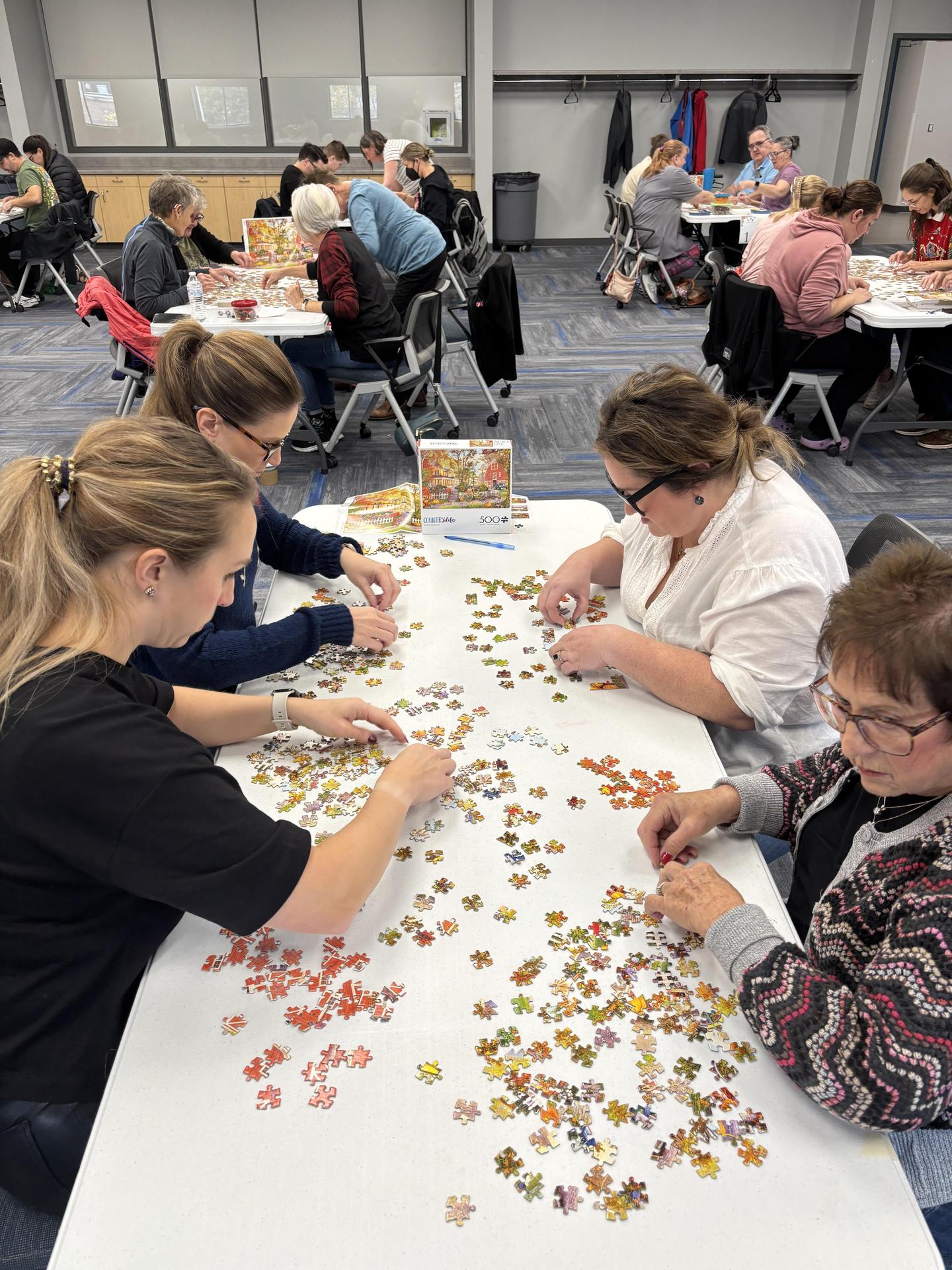 Puzzle Palooza participants putting together puzzle