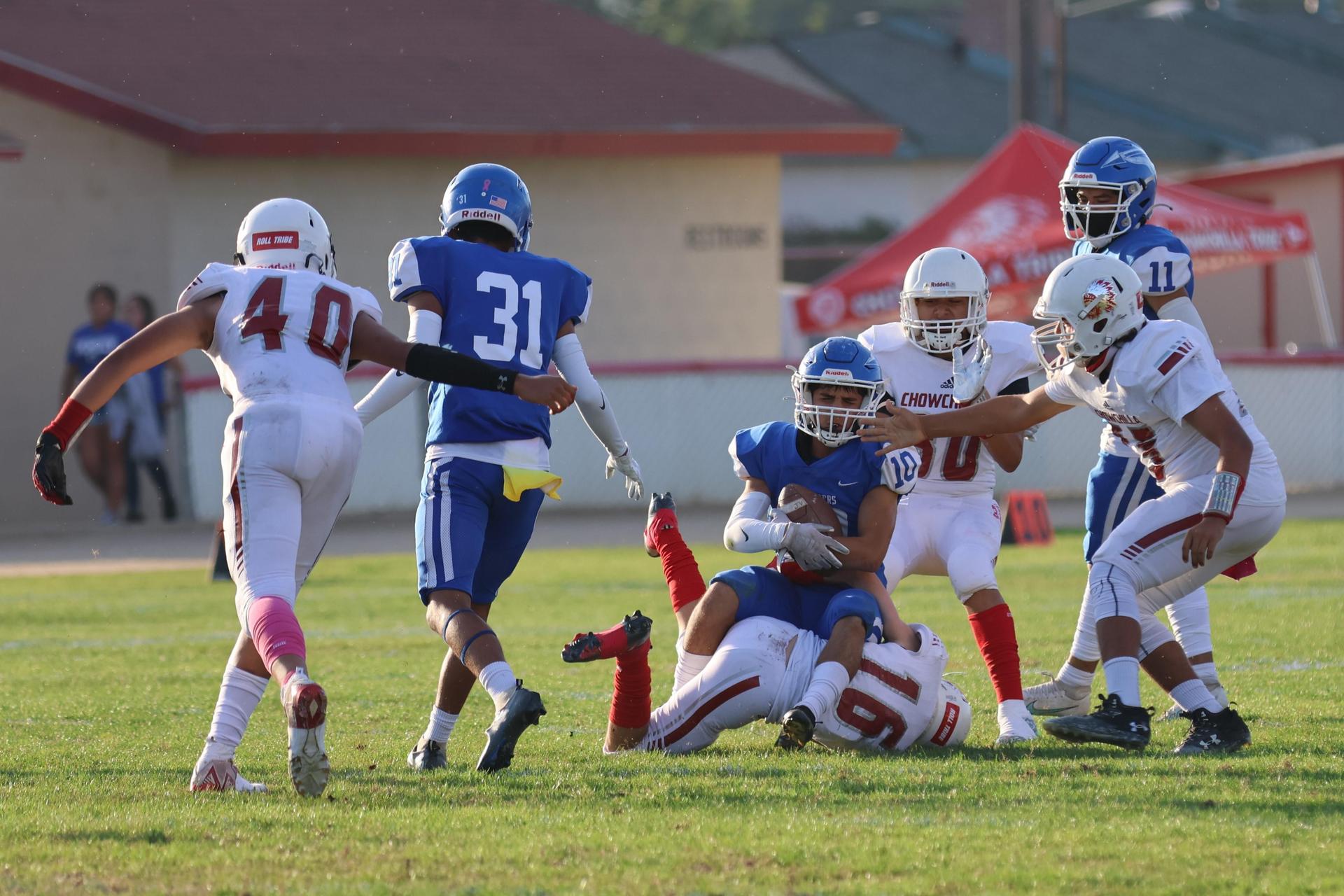 Junior Varsity football players in action against Caruthers