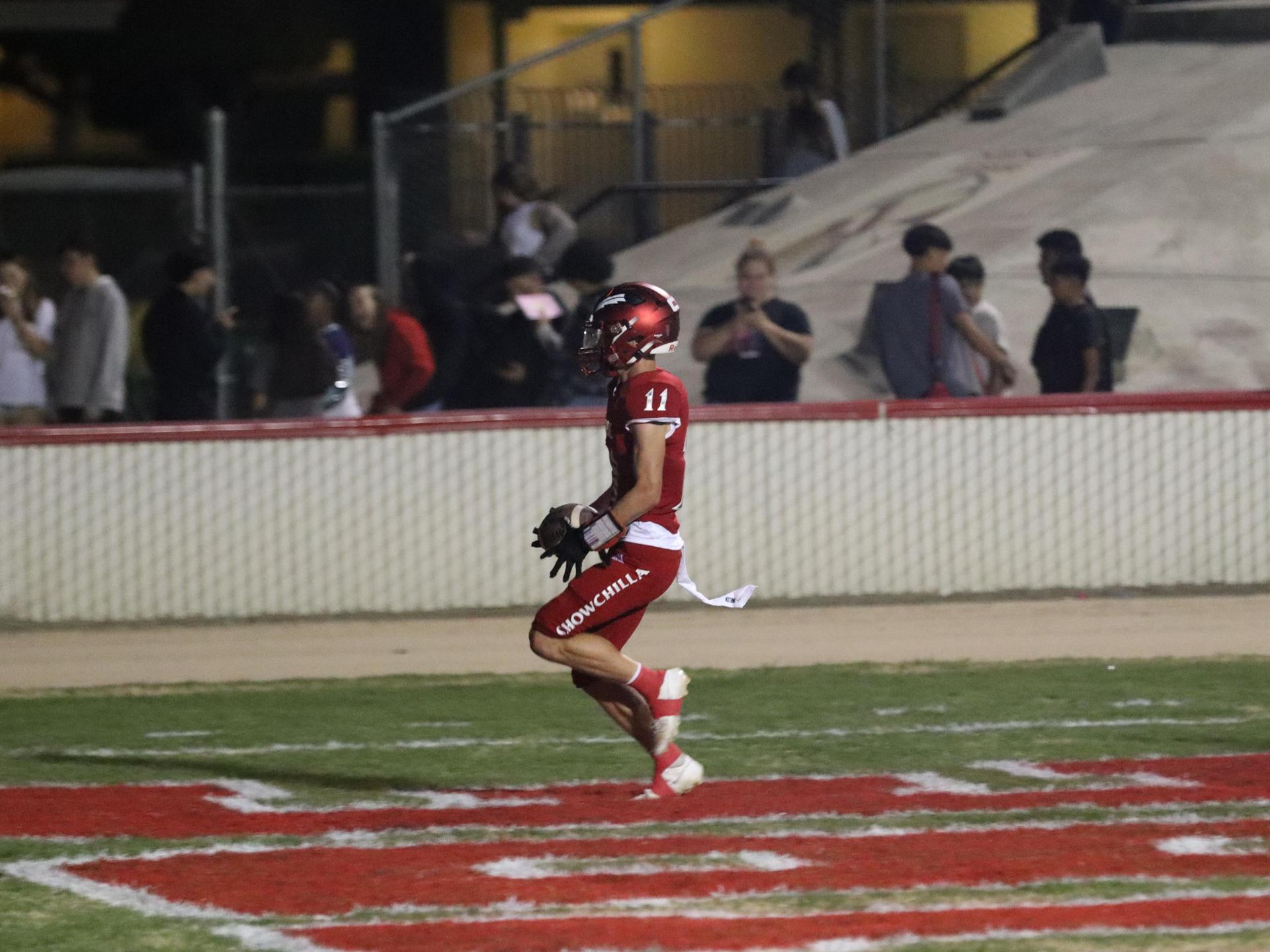 varsity football players in action against Riverdale