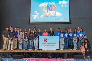 Group photo of Frenship students on the CMN stage getting the award.
