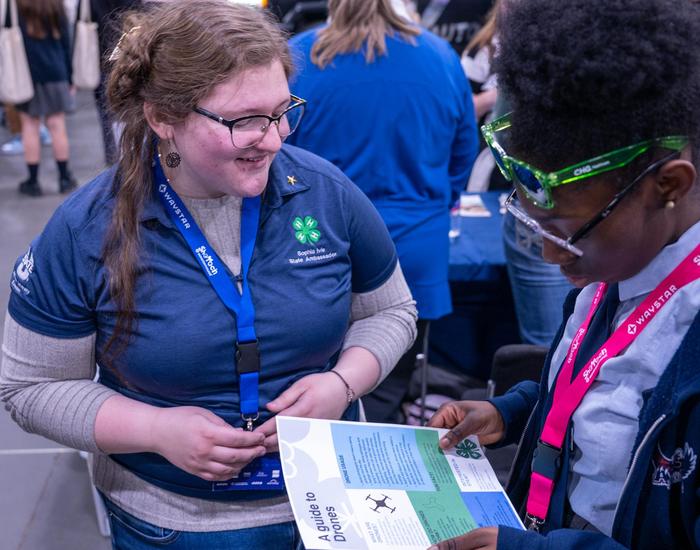 student instructing another student on using a drone